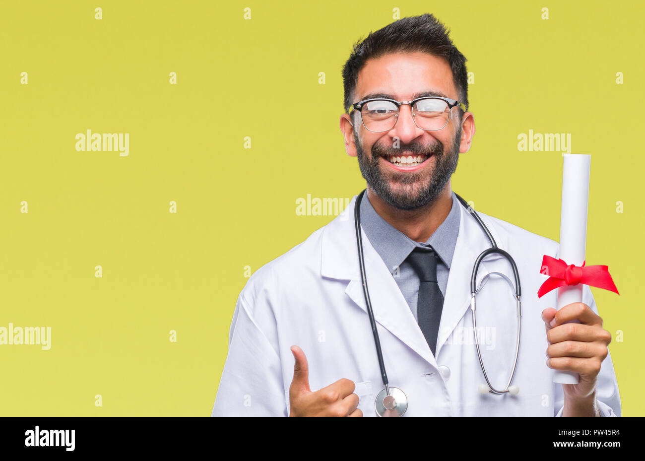 Adult hispanic doctor man holding degree over isolated background happy ...