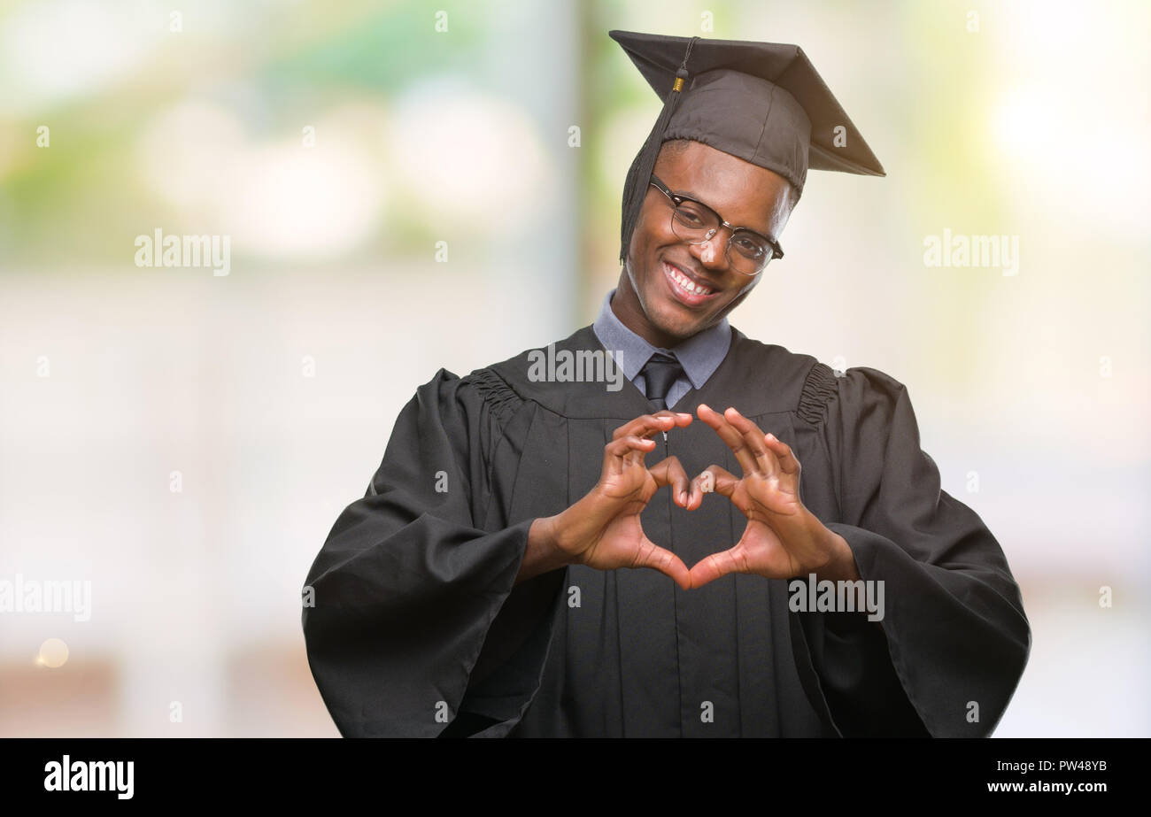 Young graduated african american man over isolated background smiling ...