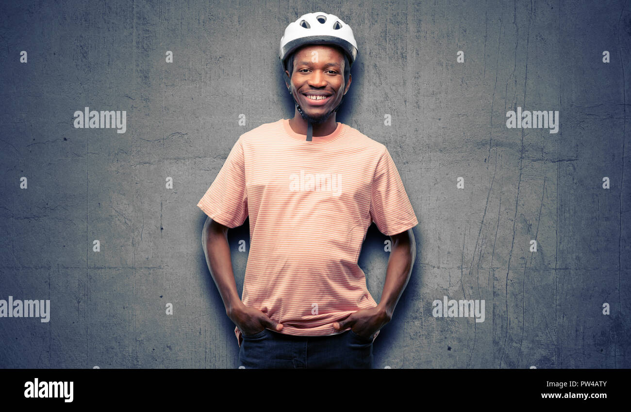 Black man wearing bike helmet confident and happy with a big natural