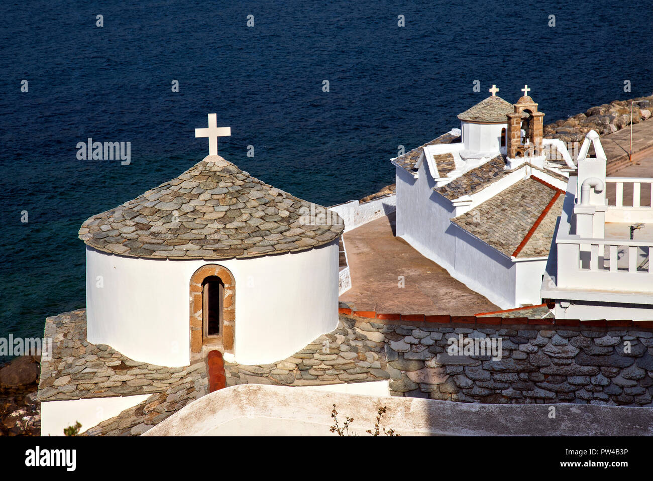 Churches in Skopelos town, Skopelos island, Northern Sporades, Greece. In the background the church of Virgin Mary, known as 'Panagitsa Tower'. Stock Photo