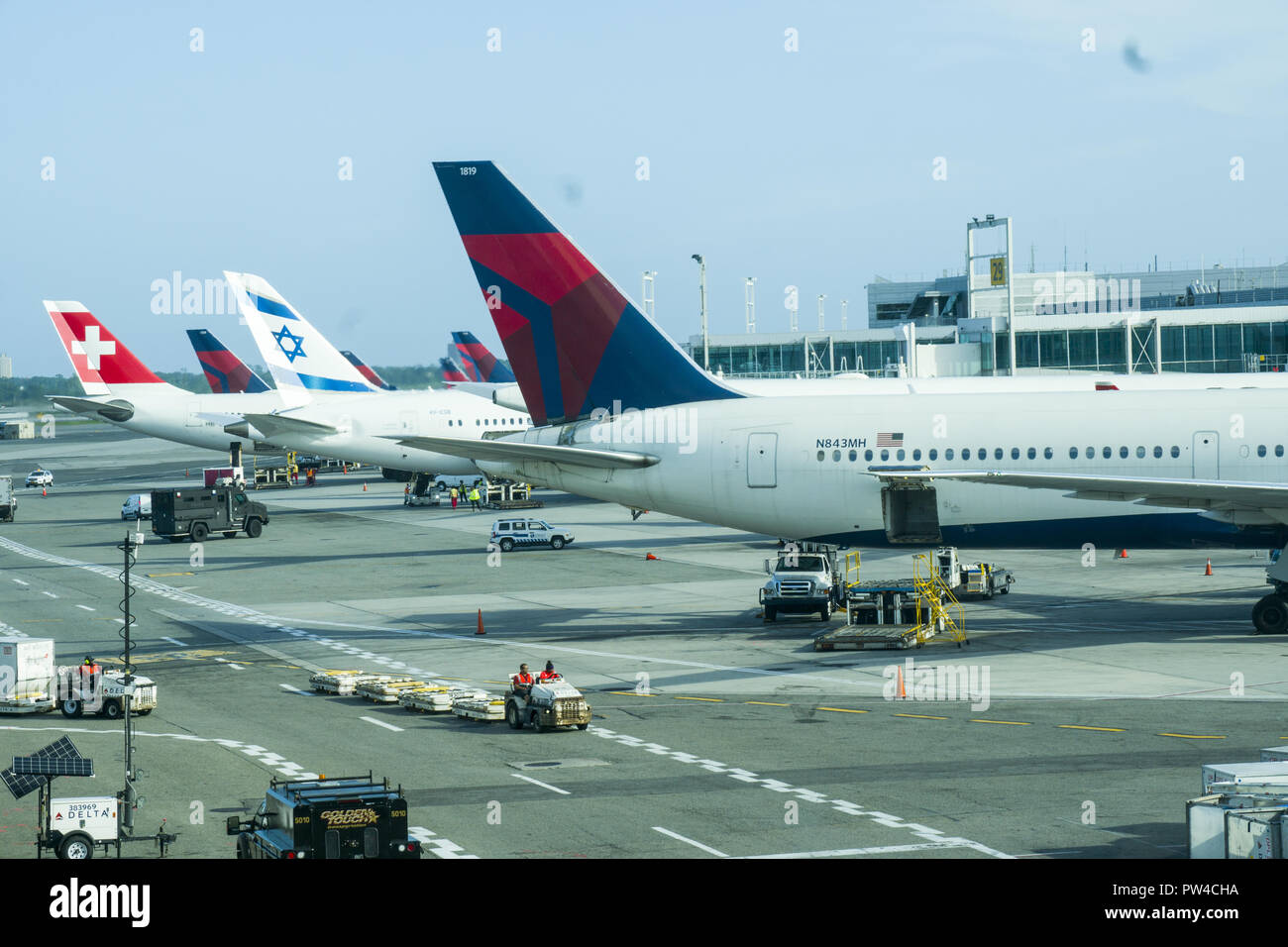 International airlines, Delta, Swiss ir and Israeli planes on the tarmac at the International Terminlal 4 at JFK in New York City. Many flights leave in the early evening to arrive in the morning in Europe. Stock Photo