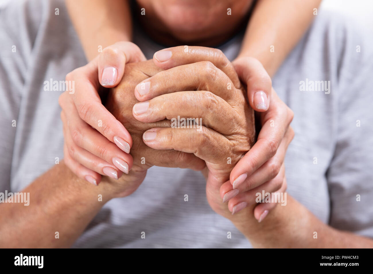 Close-up Of A Daughter Holding Hands Of Her Happy Father Stock Photo