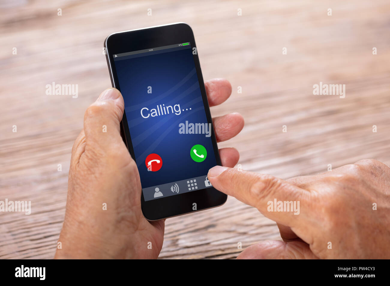 Close-up Of A Senior Man's Hand Holding Smartphone With Incoming Call Stock Photo