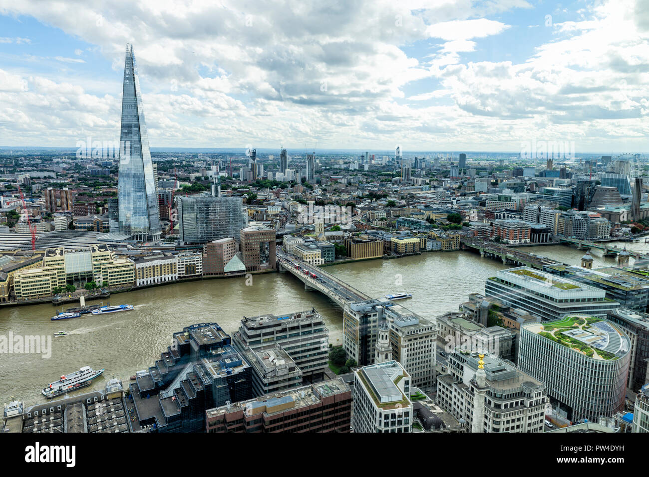 Aerial view of modern cityscape against cloudy sky Stock Photo - Alamy
