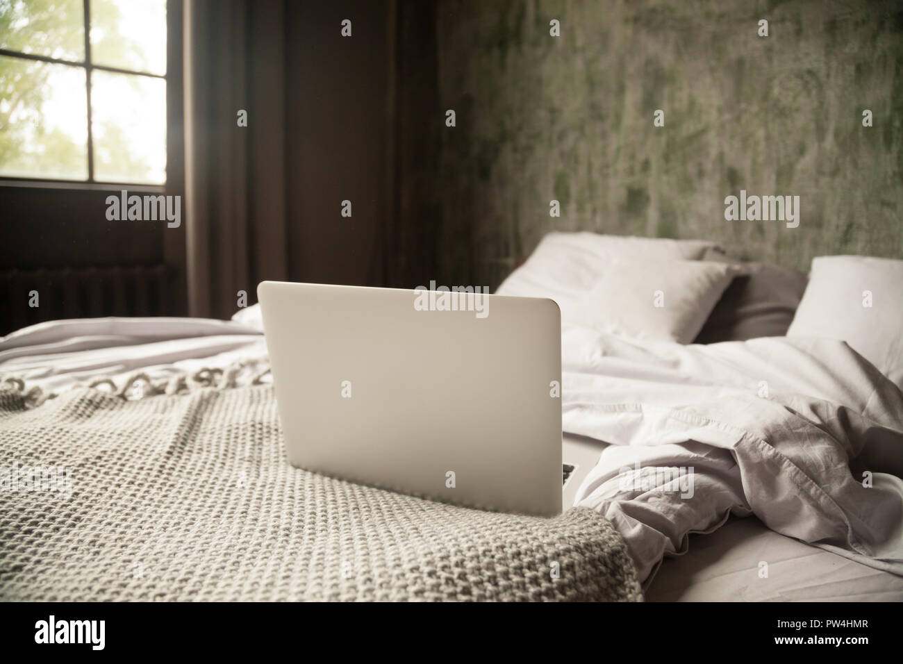 Computer on a bed in bedroom at home, nobody Stock Photo - Alamy
