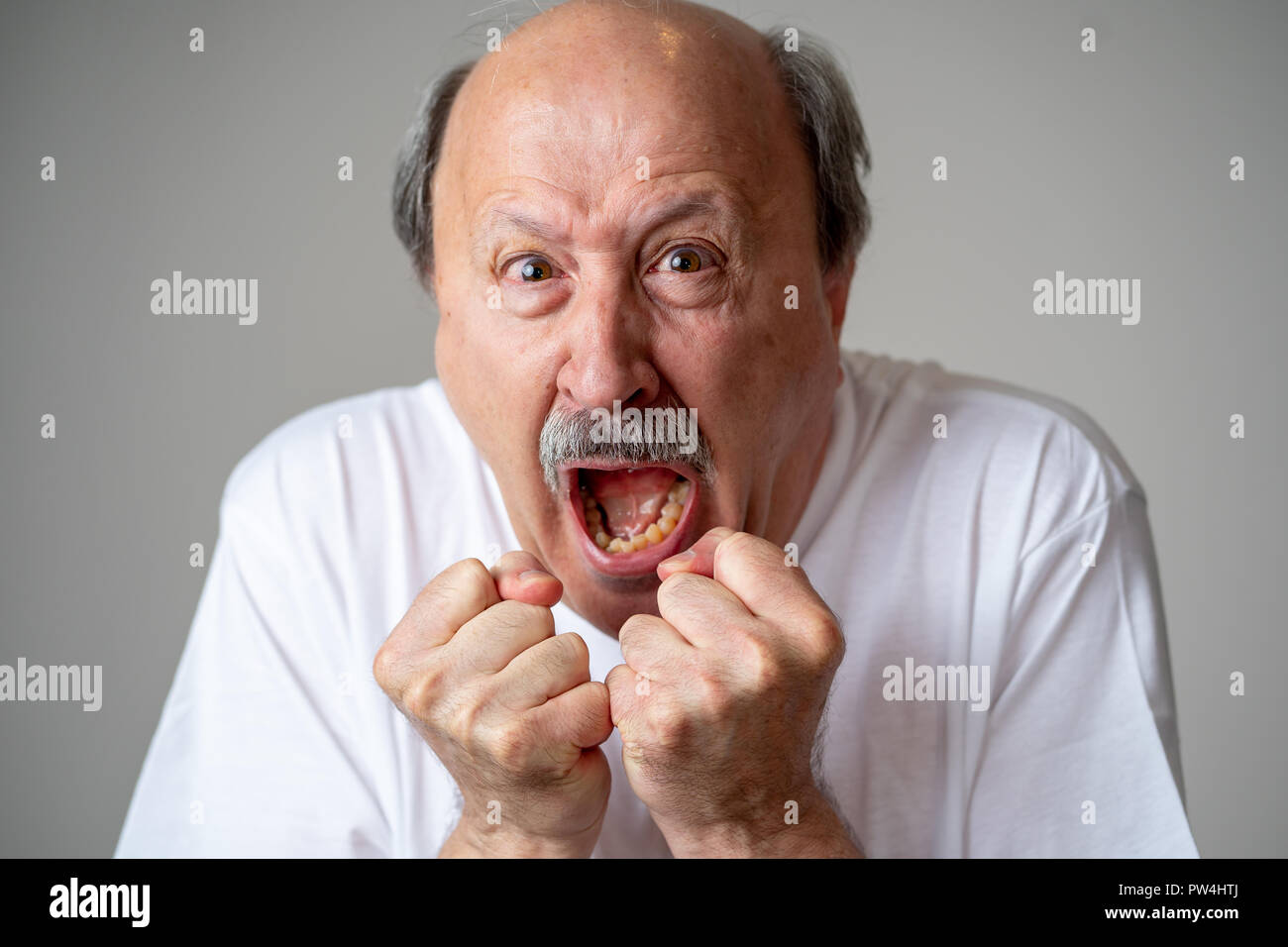 Close up portrait of a scared frightened old man in expression of fear