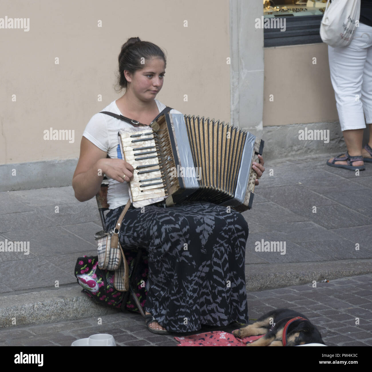 Young accordian stgreet musician in the 'Old Town district in Warsaw, Poland. Stock Photo