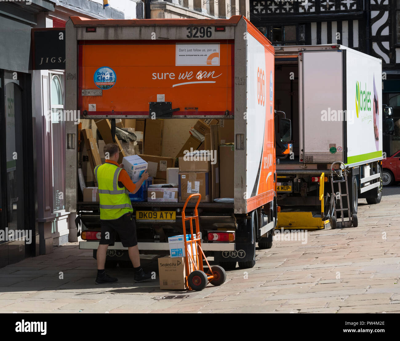 TNT delivery driver sorting packages to be delivered, Shrewsbury, Shropshire. Stock Photo