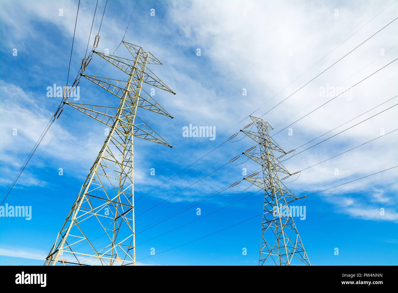 Power towers under a cloudy sky Stock Photo - Alamy