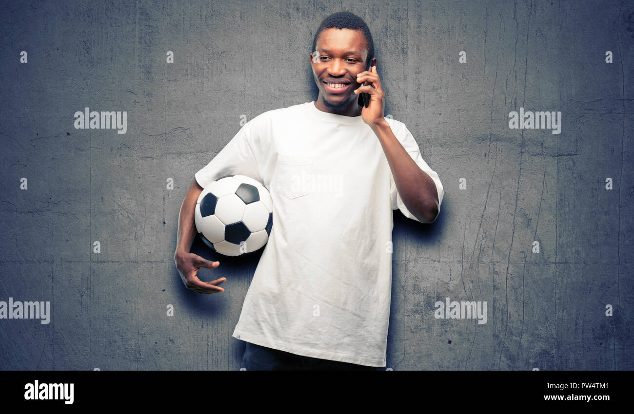 African black m happy talking using a smartphone mobile phone Stock Photo