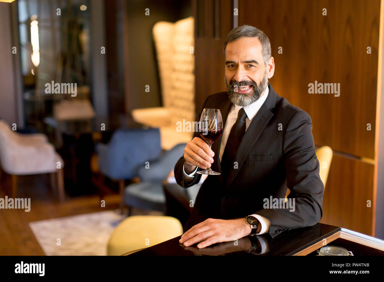 Portrait of senior handsome man drinking red wine Stock Photo - Alamy