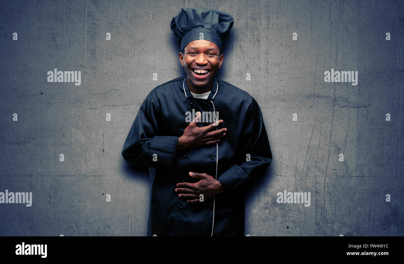 Young black cook wearing chef hat 