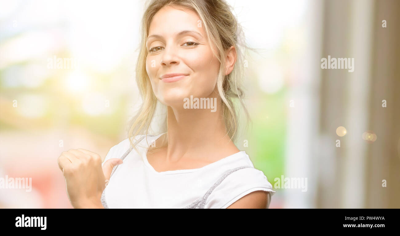 Young beautiful woman proud, excited and arrogant, pointing with victory face Stock Photo