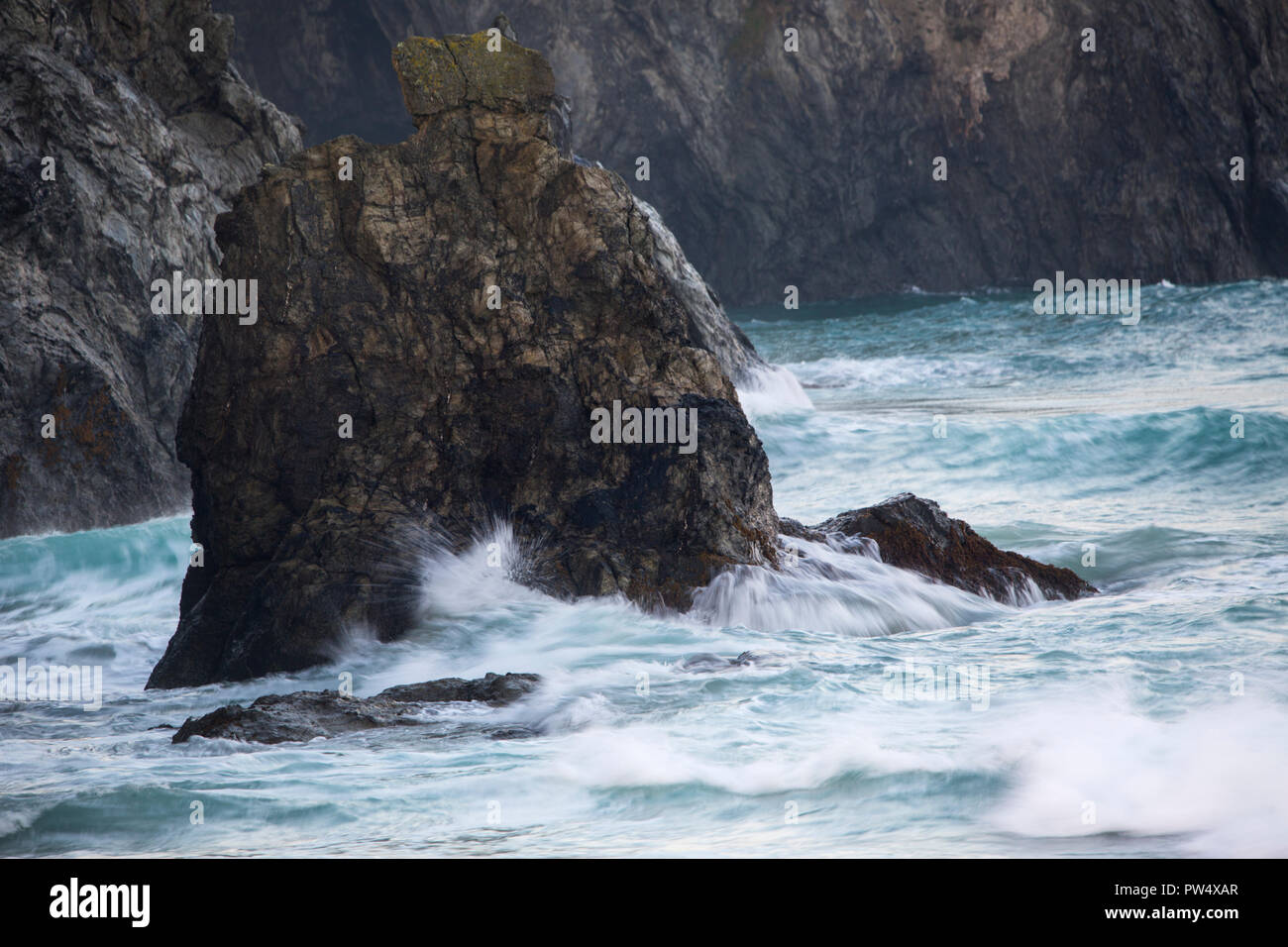 Sea Stack off the coast in rough seas at Holywell Bay in North Cornwall Stock Photo