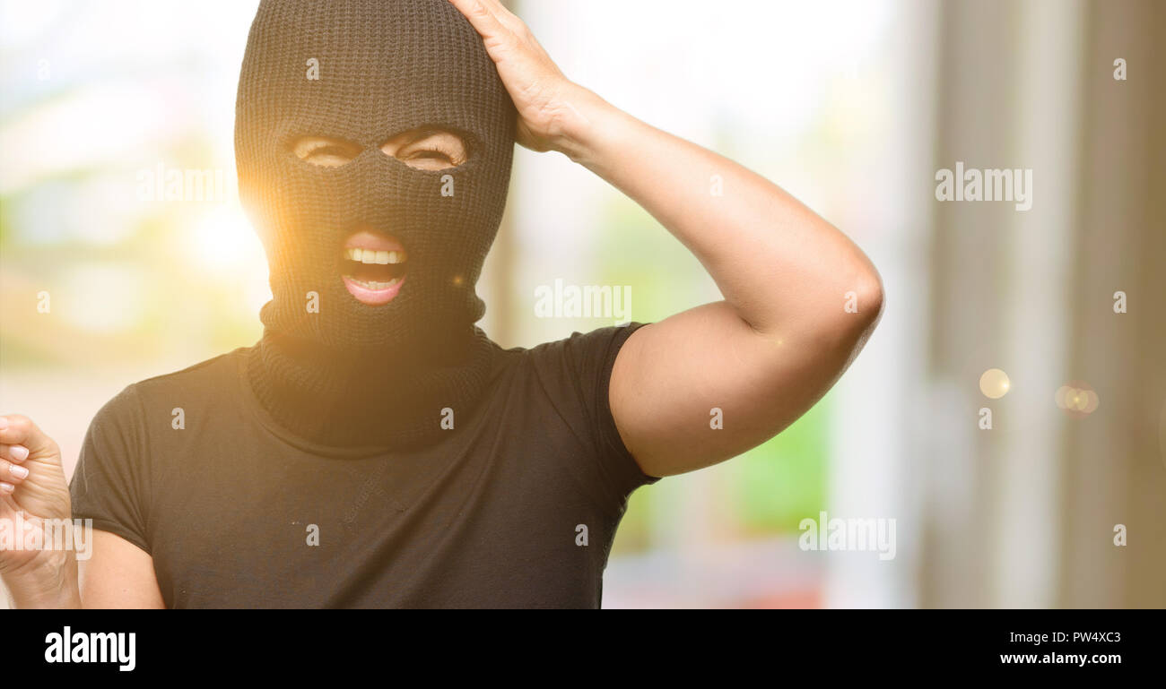 Burglar terrorist woman wearing balaclava ski mask pointing away side