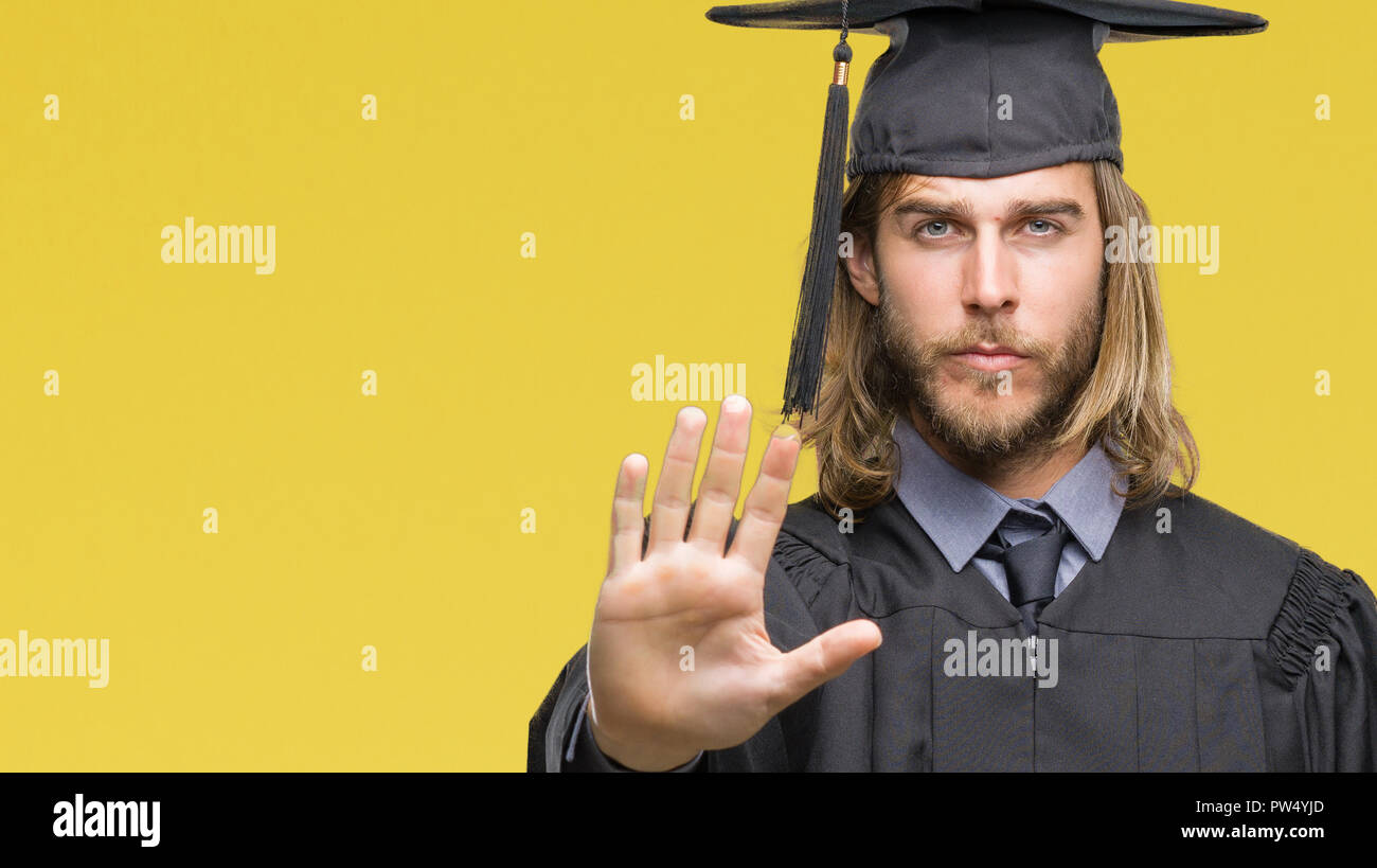 Young handsome graduated man with long hair over isolated background ...