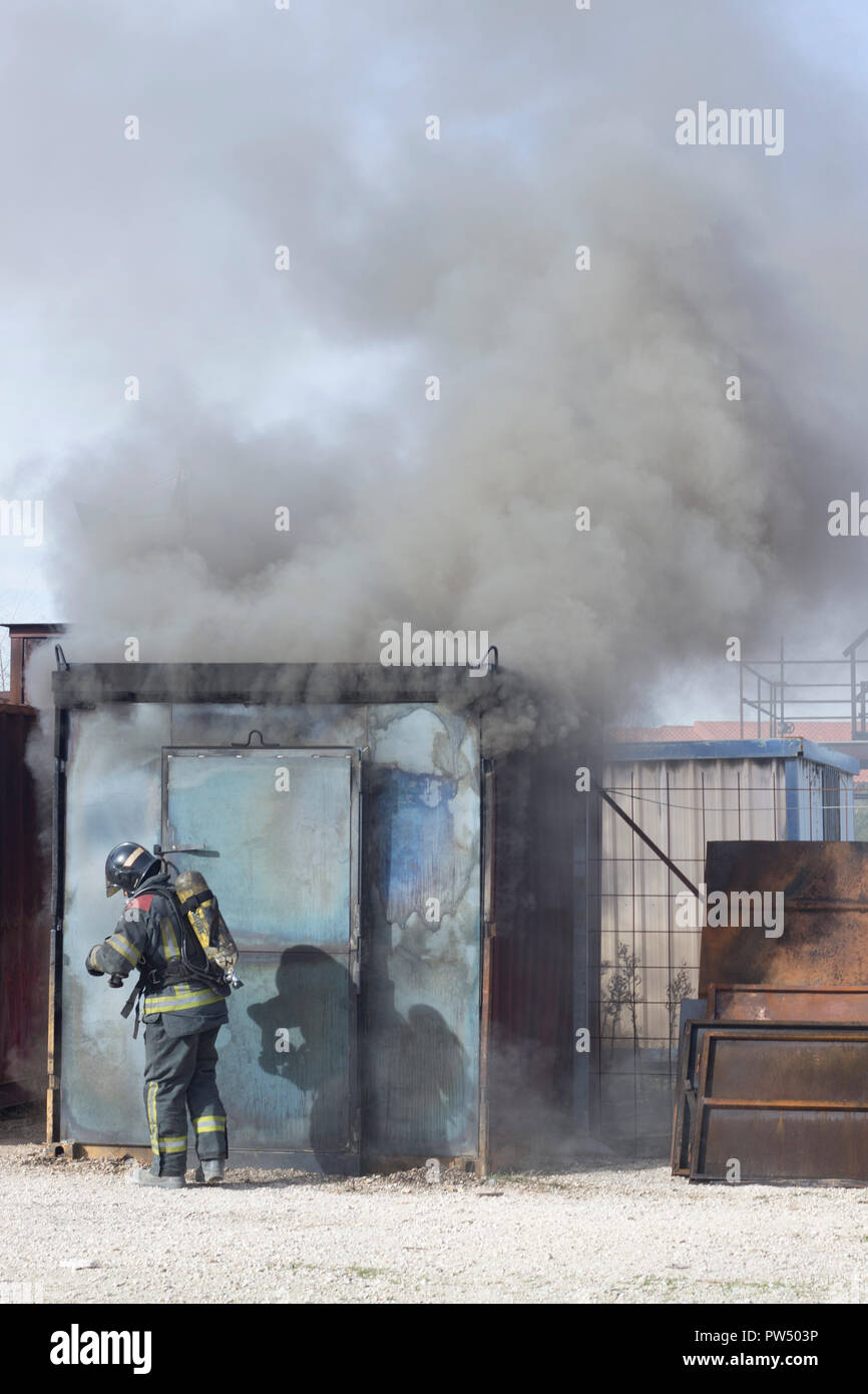 Firefighter putting out fire training station extinguisher backdraft ...