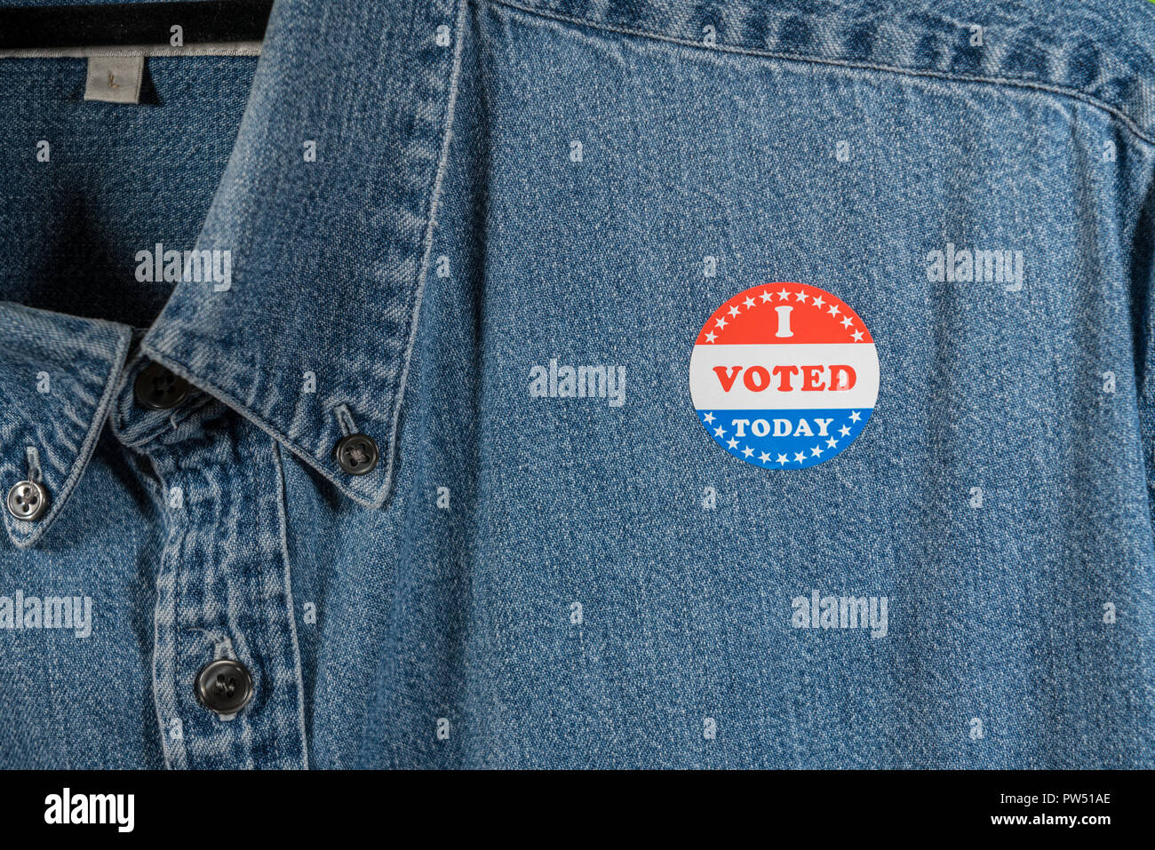 Blue denim working clothing with I Voted sticker Stock Photo