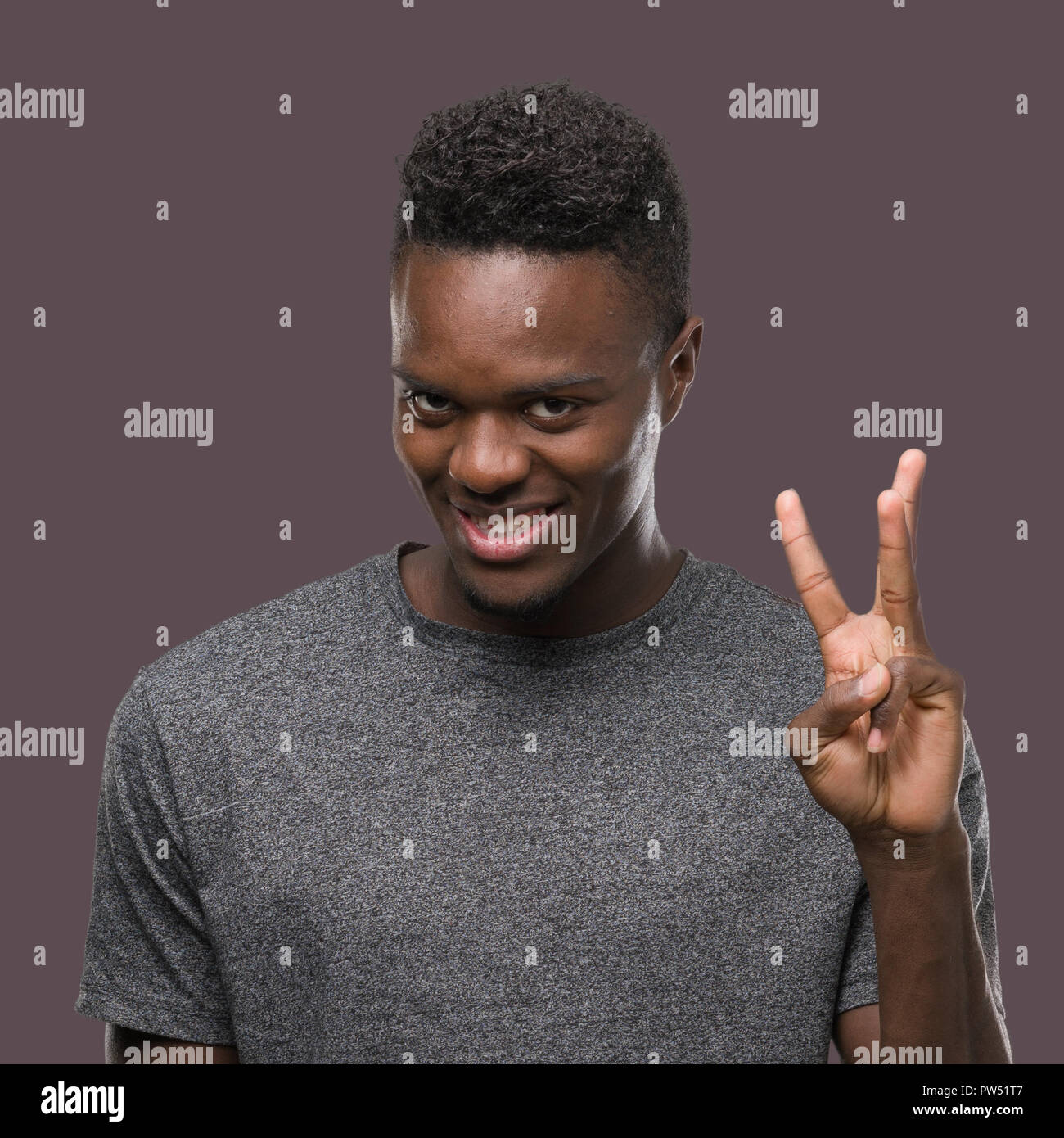 Young African American Man Wearing Grey T Shirt Showing And