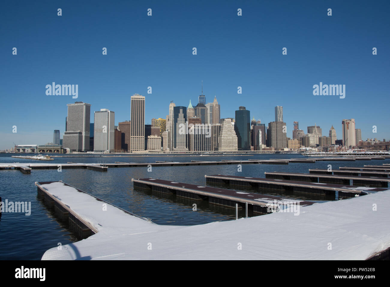 View of Manhattan across New York Harbour from Brooklyn on a clear and snowy morning Stock Photo