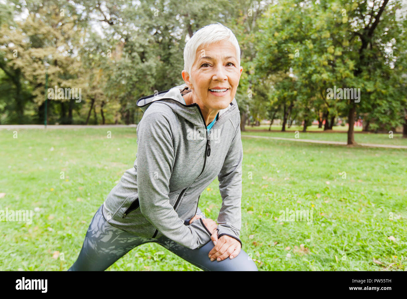 Mature Fit Woman In Sportswear Doing Fitness Exercise In Nature, Workout  Outdoor Stock Photo - Alamy