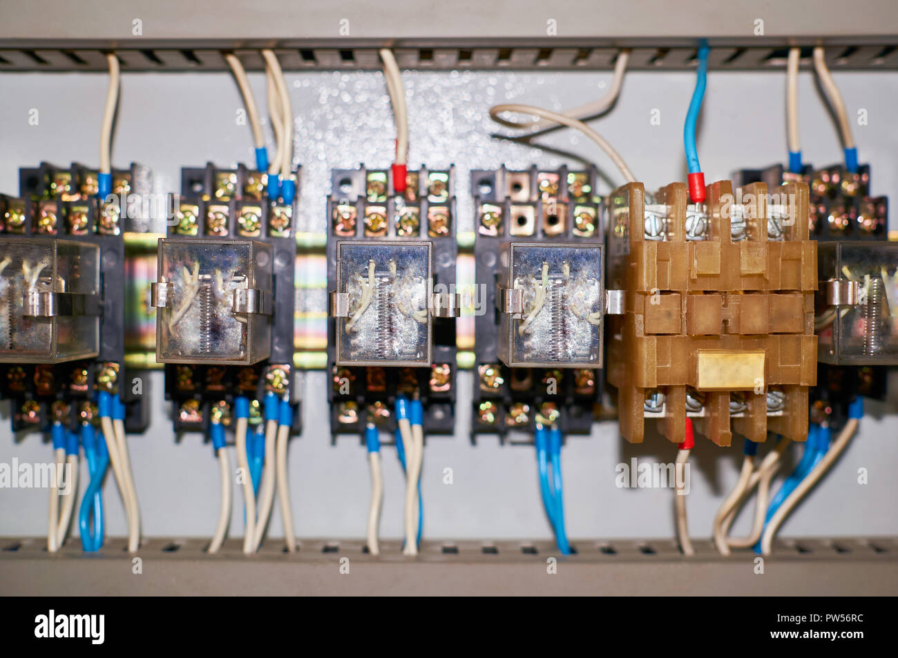 Several old relays with connected colored wires. Industrial background. Stock Photo