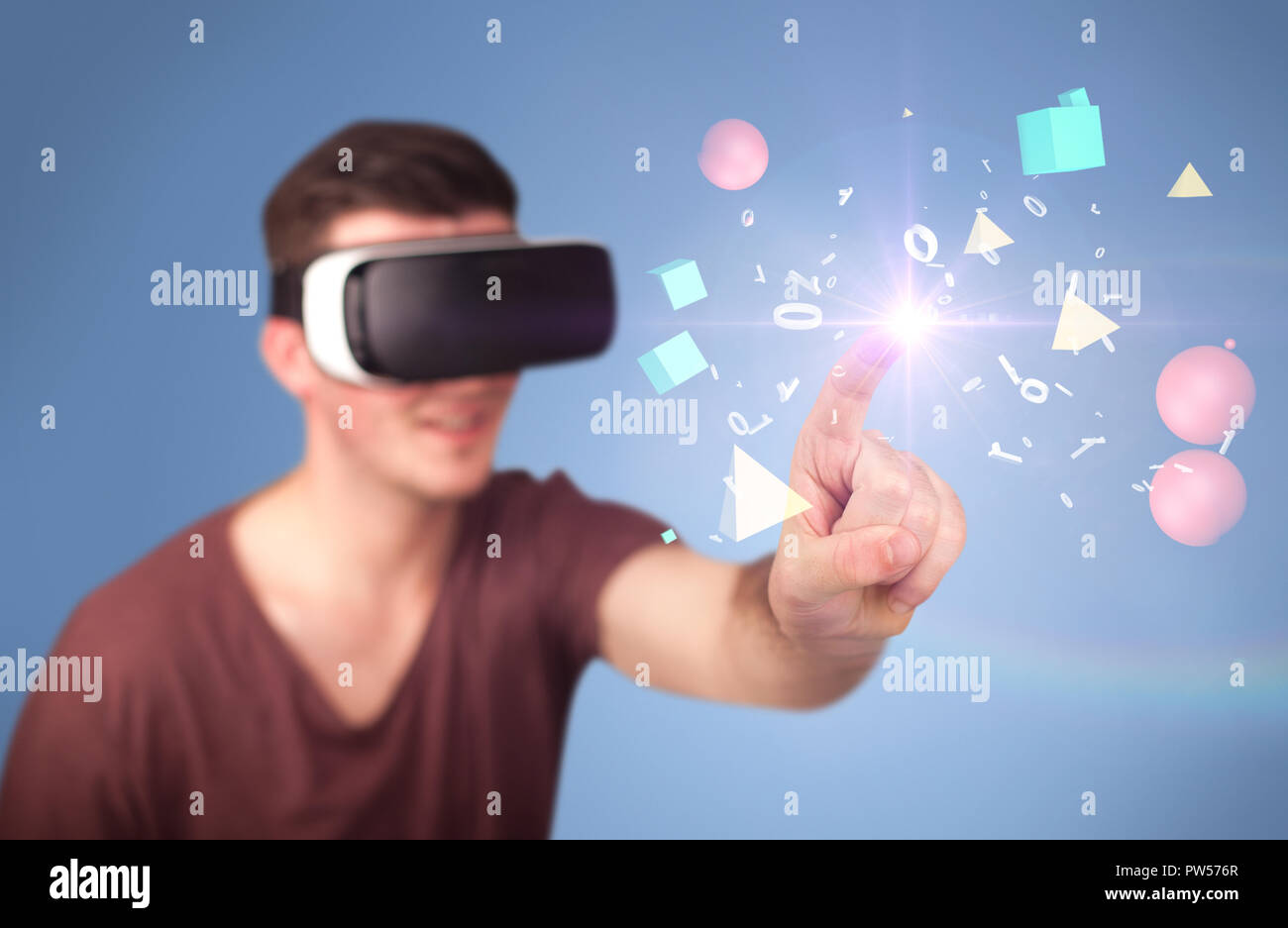 Young impressed man wearing virtual reality goggles with geometric ...