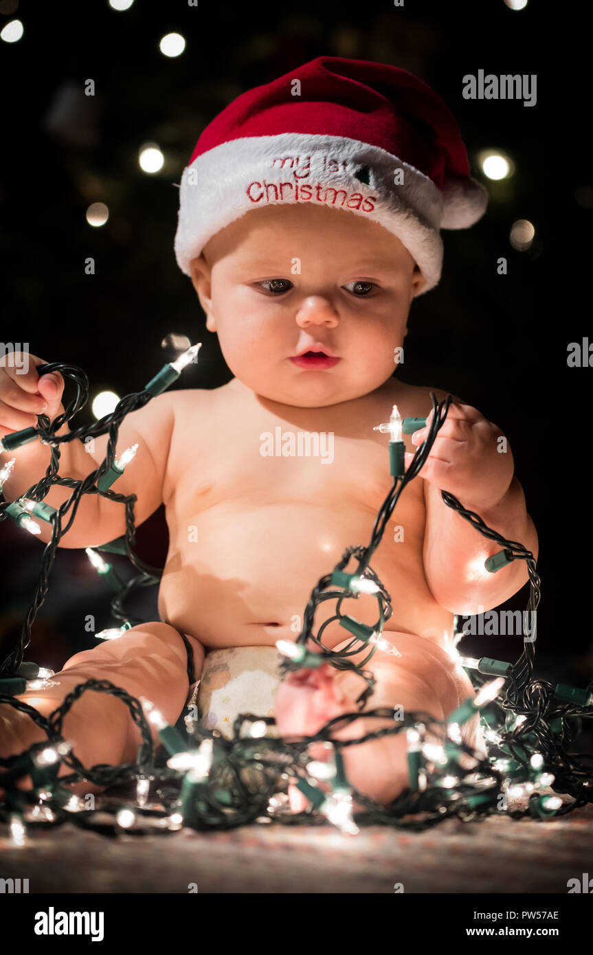 Baby at Christmas with Tree Lights Stock Photo Alamy
