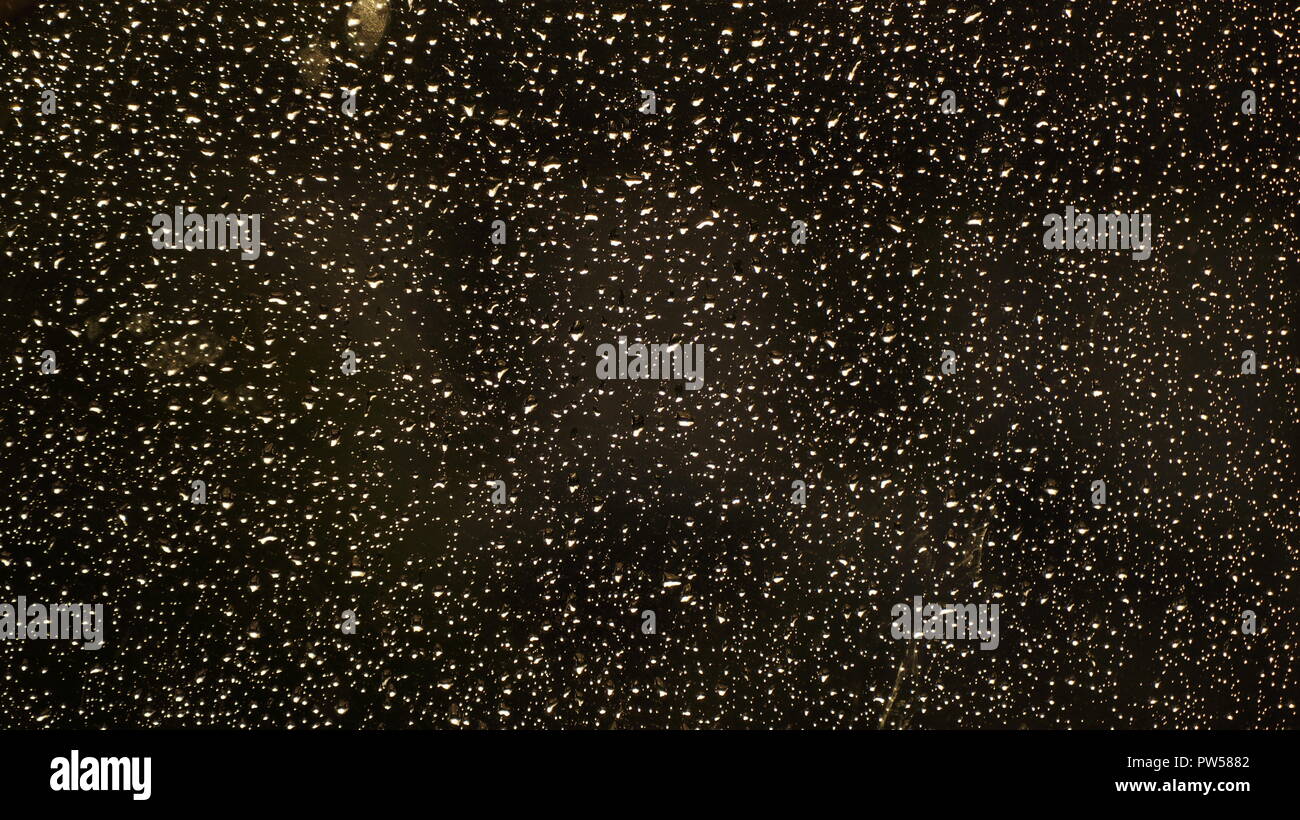 Rain Water Droplets on Glass Dark Background Stock Photo