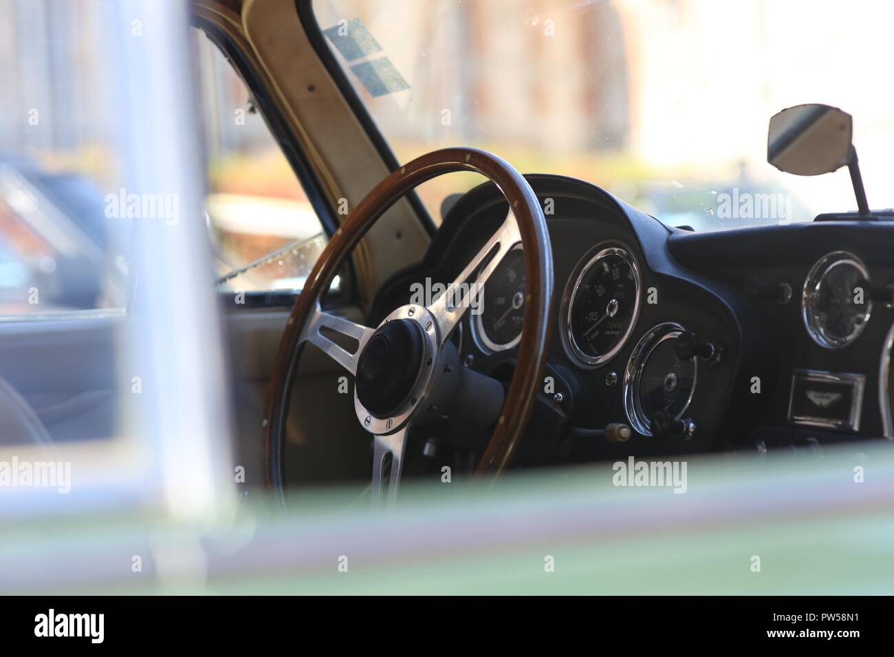 In the Cockpit of an Aston Martin DB4 at Château de Neuville in Gambais (78) – France. Stock Photo