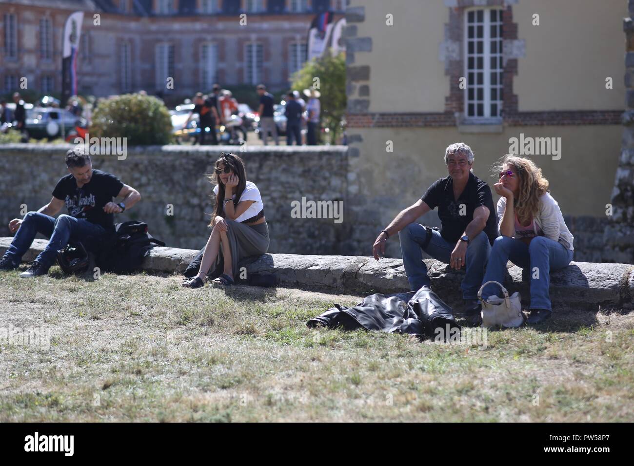 Bikers taking a break in the sun at Château de Neuville in Gambais (78) – France. Stock Photo