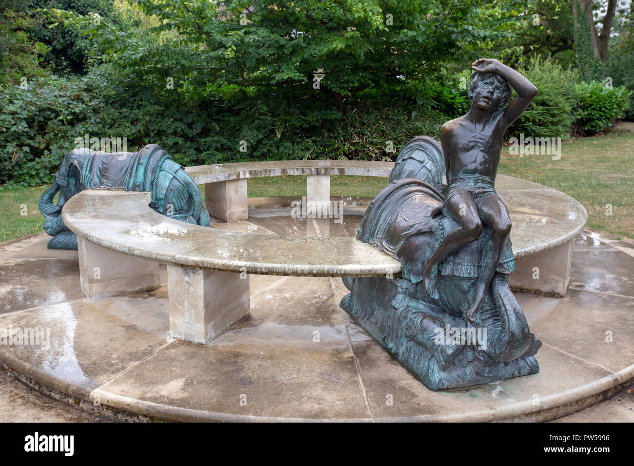 JEPHSON GARDENS, LEAMINGTON SPA, ENGLAND - August 10, 2018: An unusual bronze and marble seat sculpture with elephants and a boy in Jephson Gardens, L Stock Photo