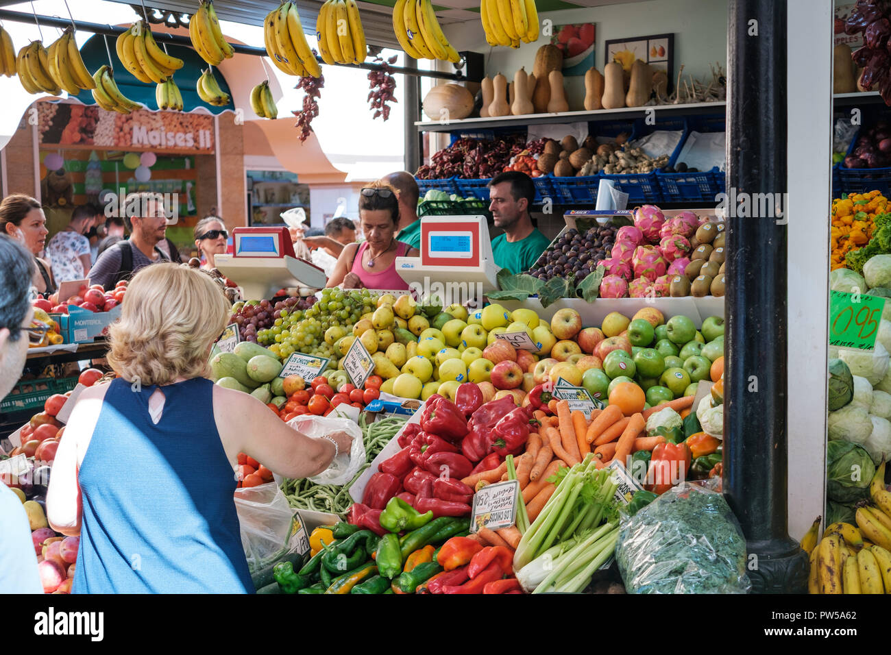 Santa Cruz de Tenerife, Canary Islands, Spain - September 2018: People buying fruits and vegetables at food market Municipal Market Our Lady of Africa Stock Photo