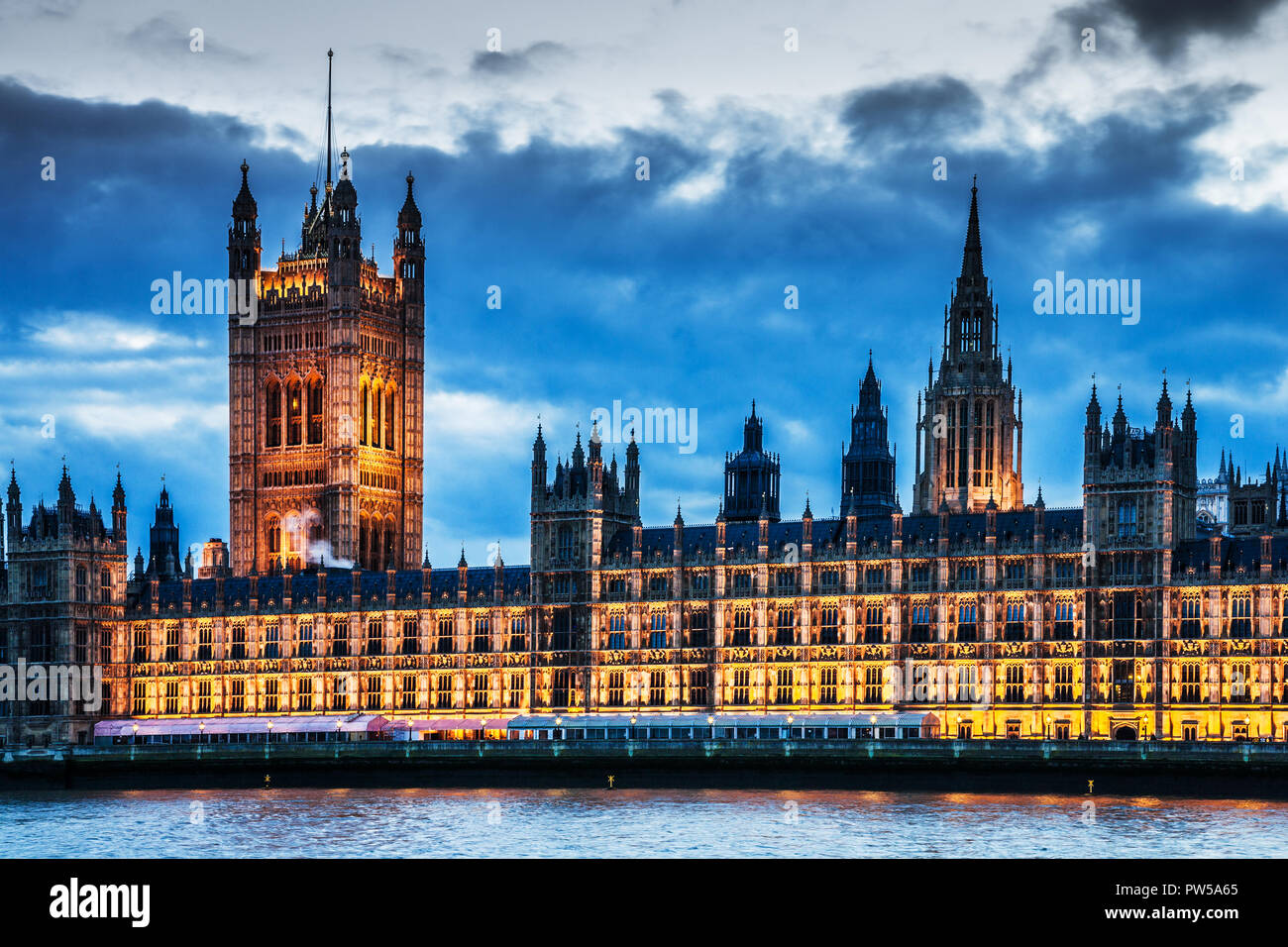 The Houses of Parliament along the river Thames in London at night. Stock Photo