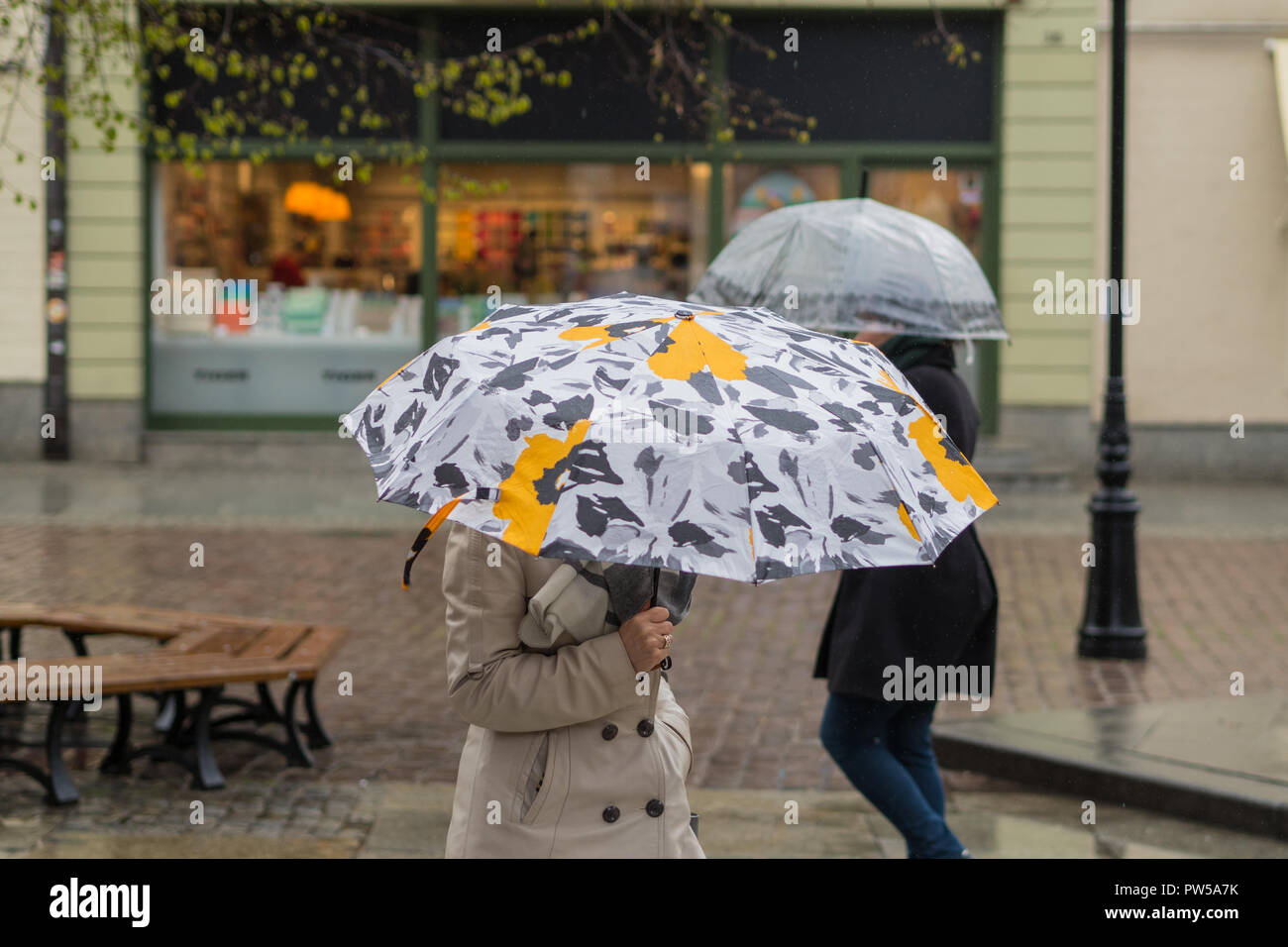 two umbrellas on a rainy street Stock Photo