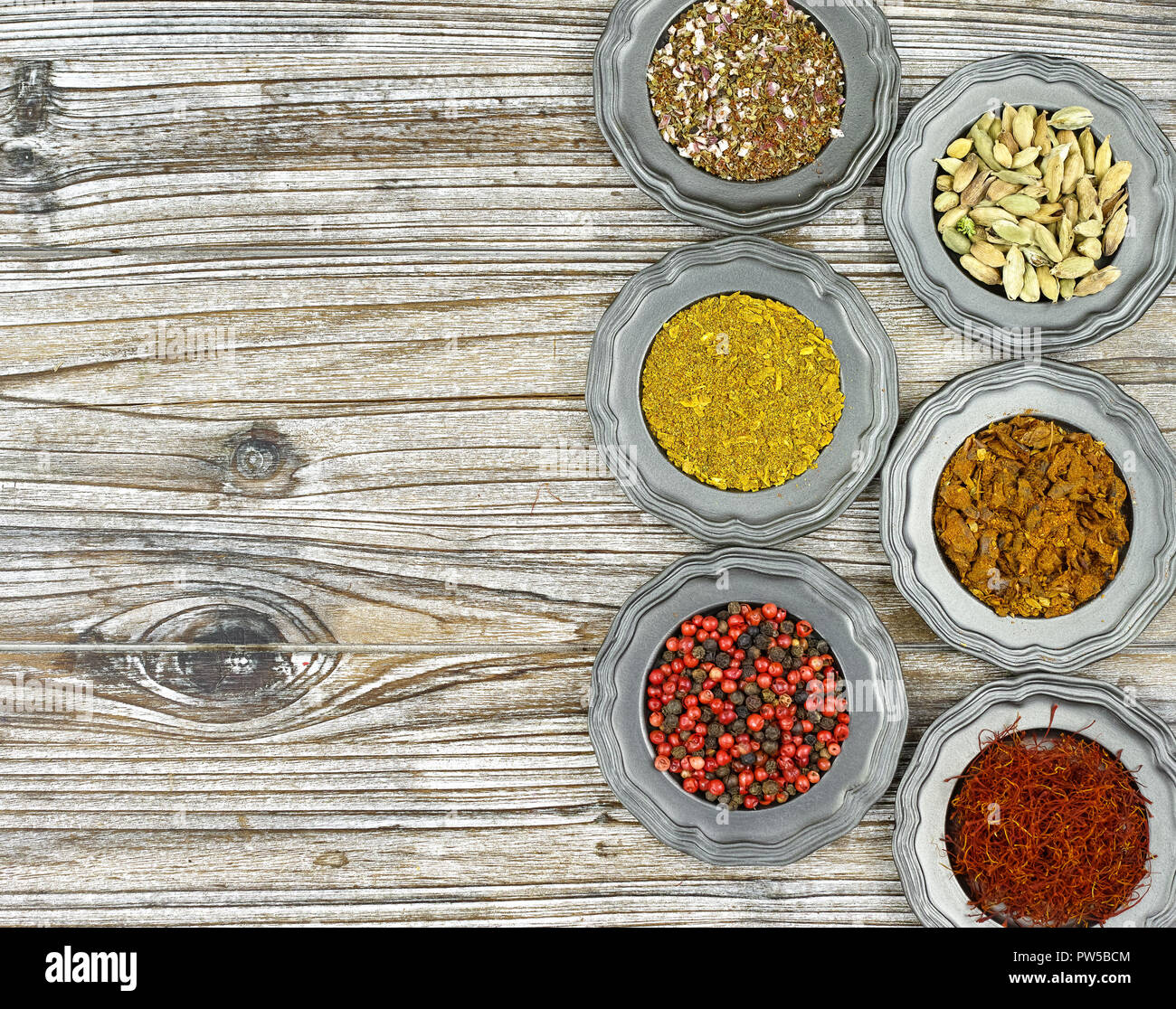Flat lay concept, copy space, six mixed dried spices in vintage tin bowls top view Stock Photo