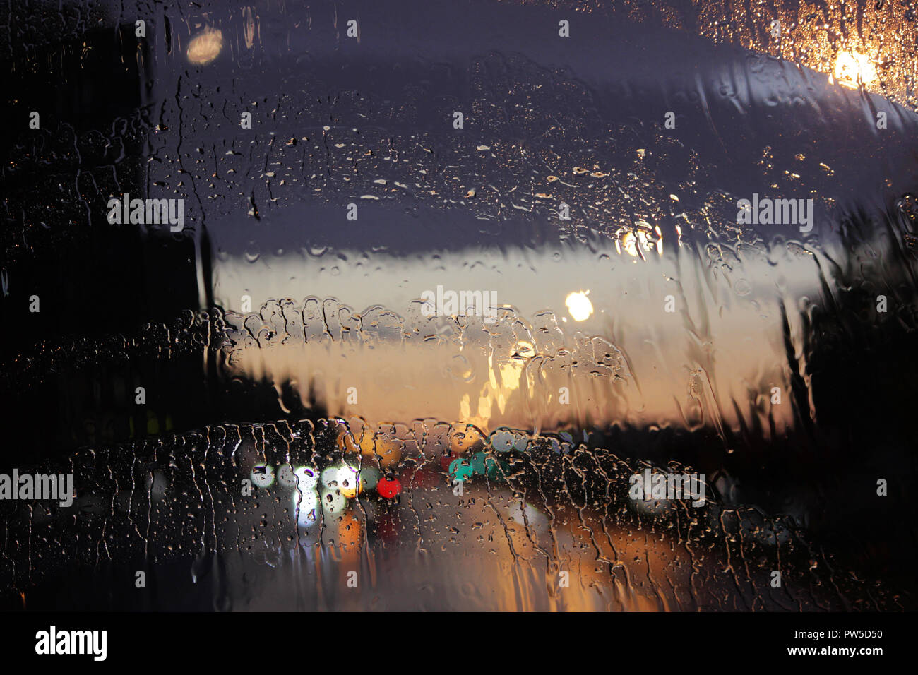 Homecoming. Bokeh lights, wet blurred view of road traffic in Gatchina ...