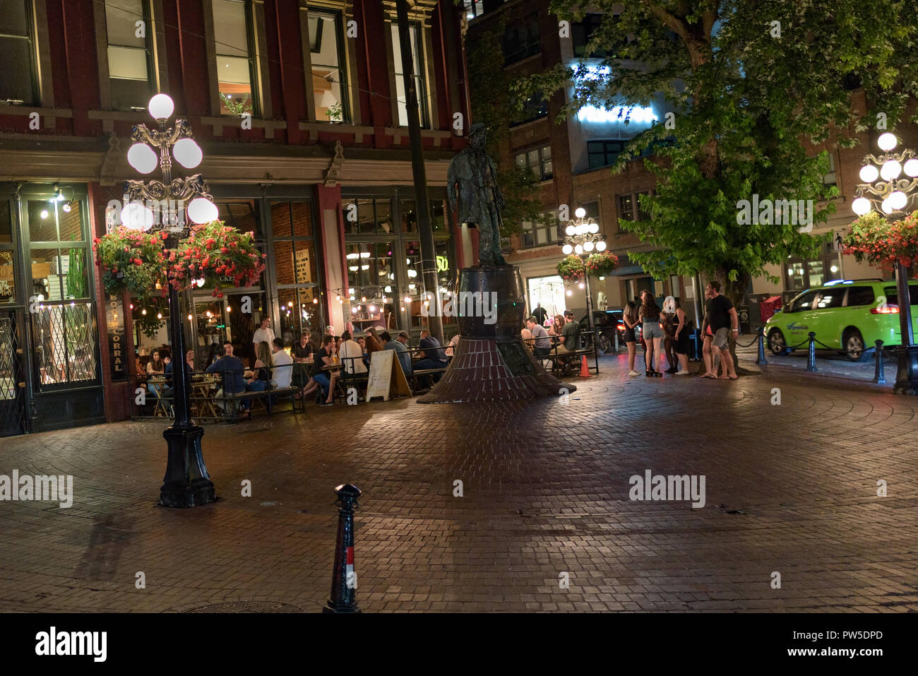 young people meet bar enjoy drink summer later night in gas town Vancouver  Canada Stock Photo