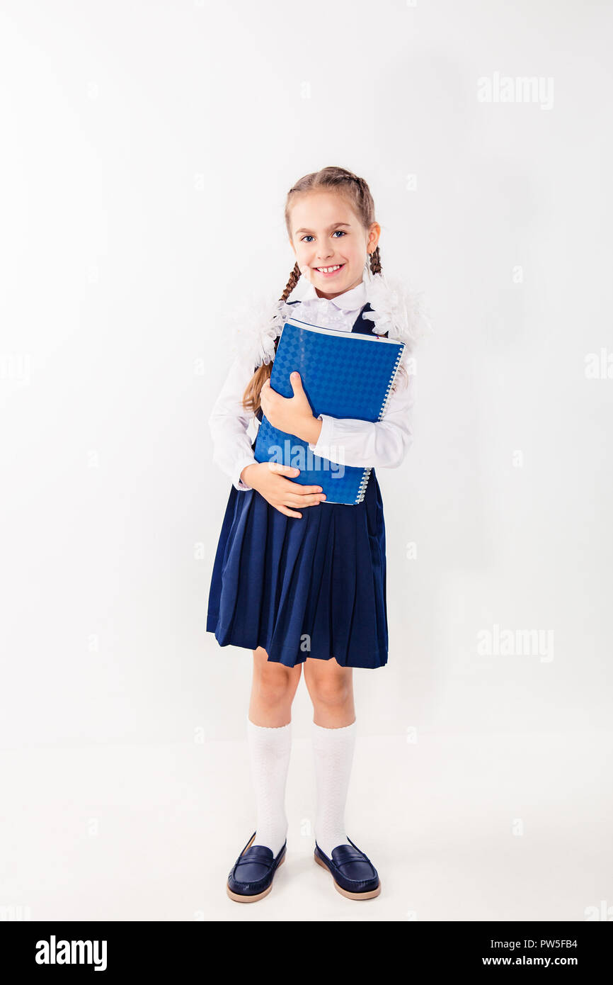 Cute schoolgirl with notebooks and books on a white background ...