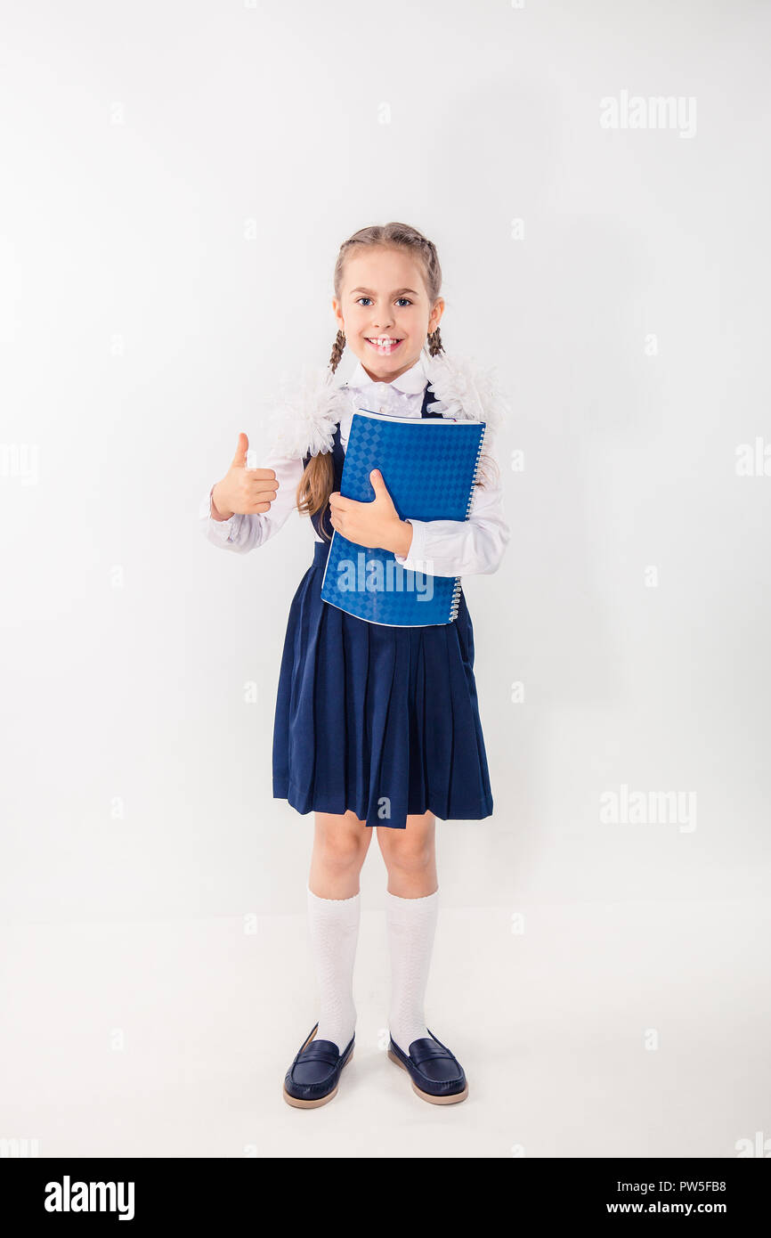 Cute schoolgirl with notebooks and books on a white background ...