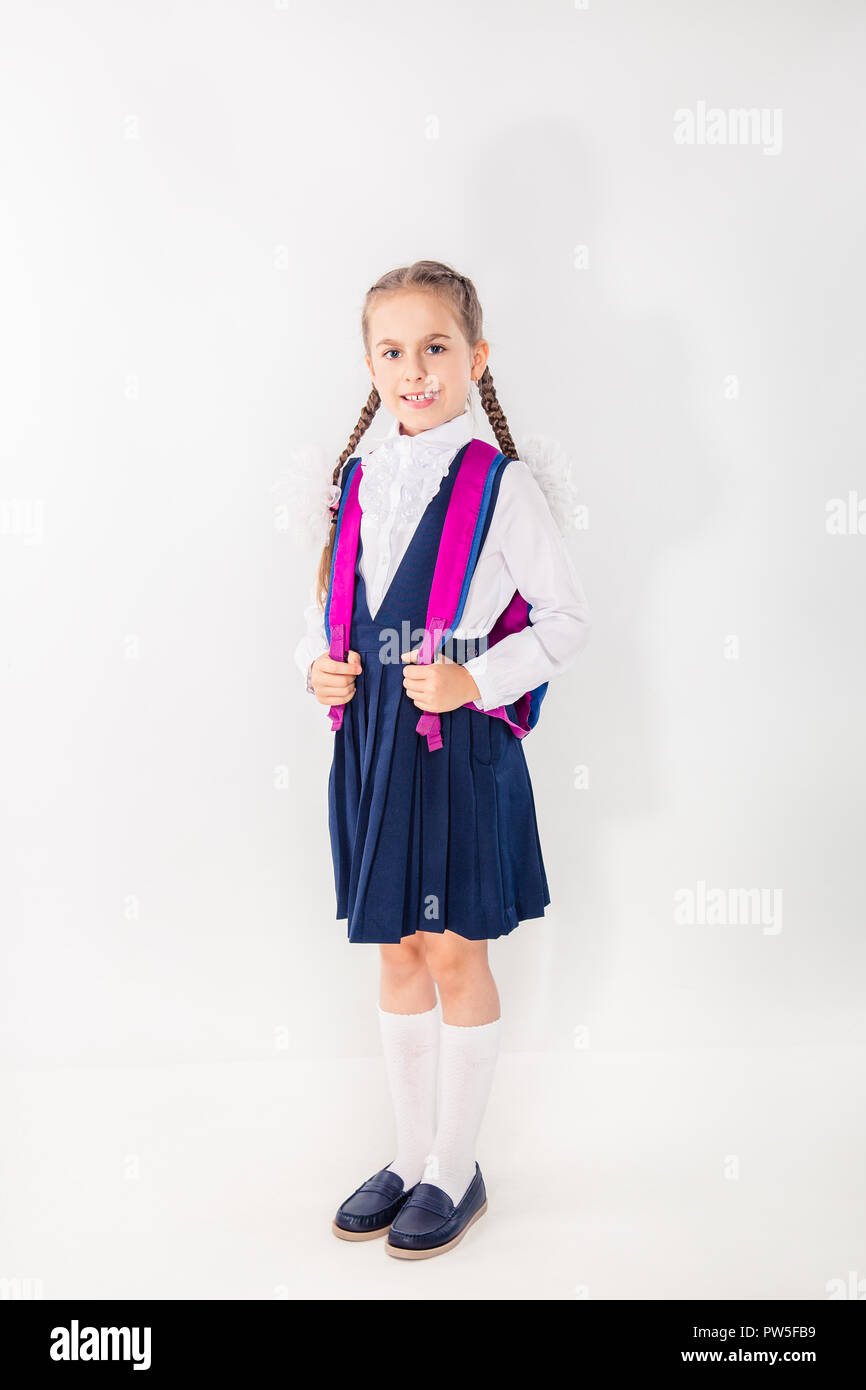Cute schoolgirl with notebooks and books on a white background ...