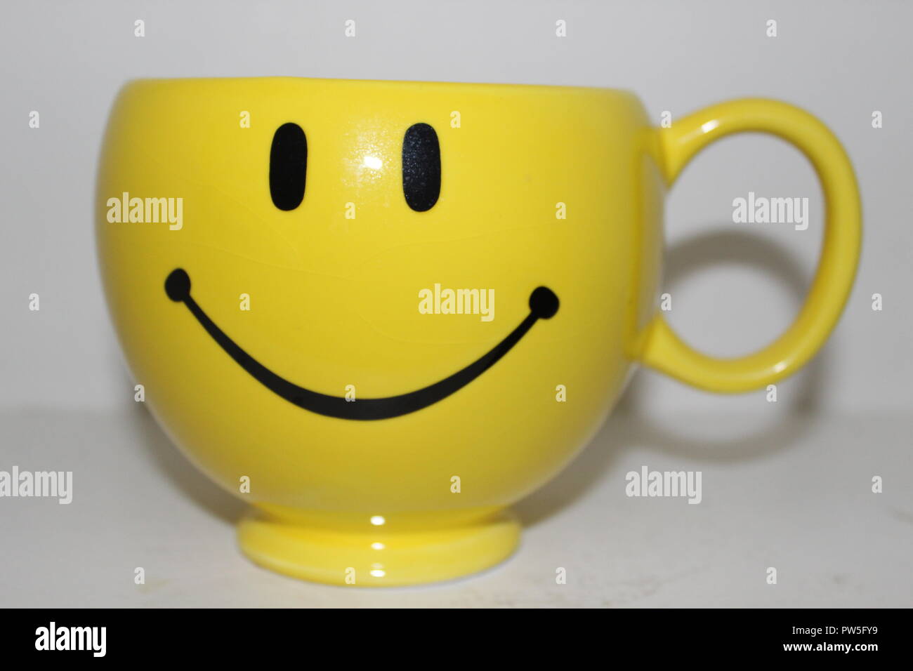 Yellow cup with smiley face design Stock Photo