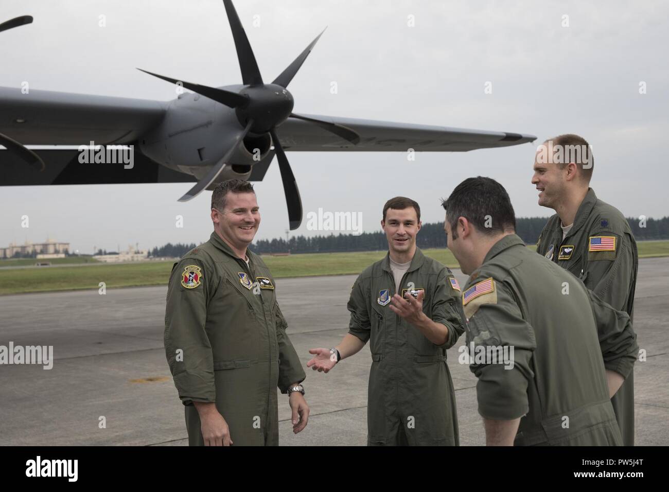 Crewmembers with the 36th Airlift Squadron talks after landing at Yokota Air Base, Japan, Sept. 20, 2017. This is the fifth C-130J delivered to Yokota and the first from Ramstein Air Base. Crewmembers from the 36th Airlift Squadron flew halfway around the world to deliver the aircraft here. Yokota serves as the primary Western Pacific airlift hub for U.S. Air Force peacetime and contingency operations. Missions include tactical airland, airdrop,aeromedical evacuation, special operations and distinguished visitor airlift. Stock Photo
