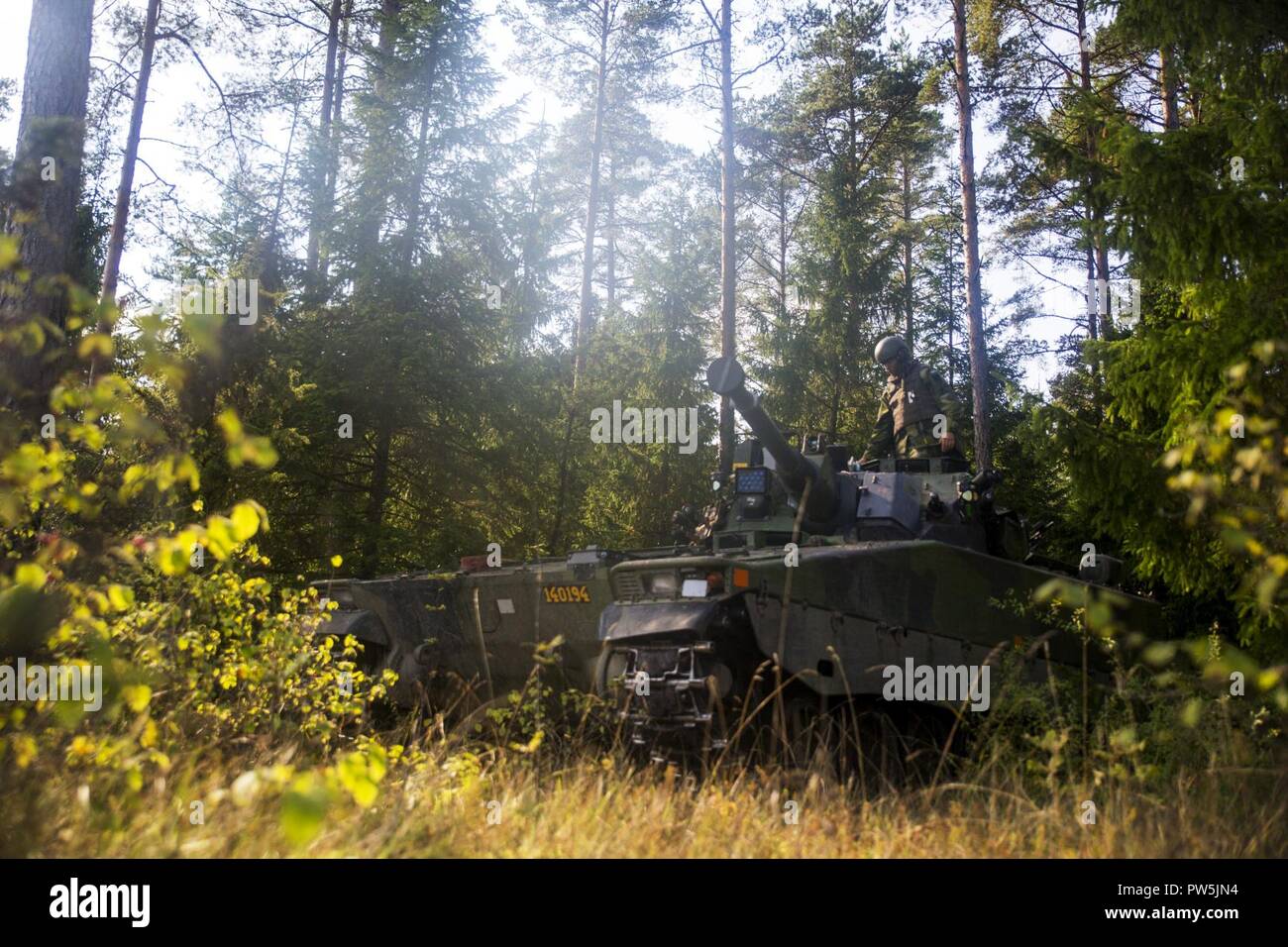 Swedish soldier changes turret position of the Swedish Strf-90 tracked ...