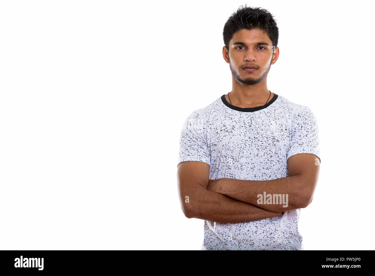 Studio shot of young handsome Indian man with arms crossed Stock Photo ...