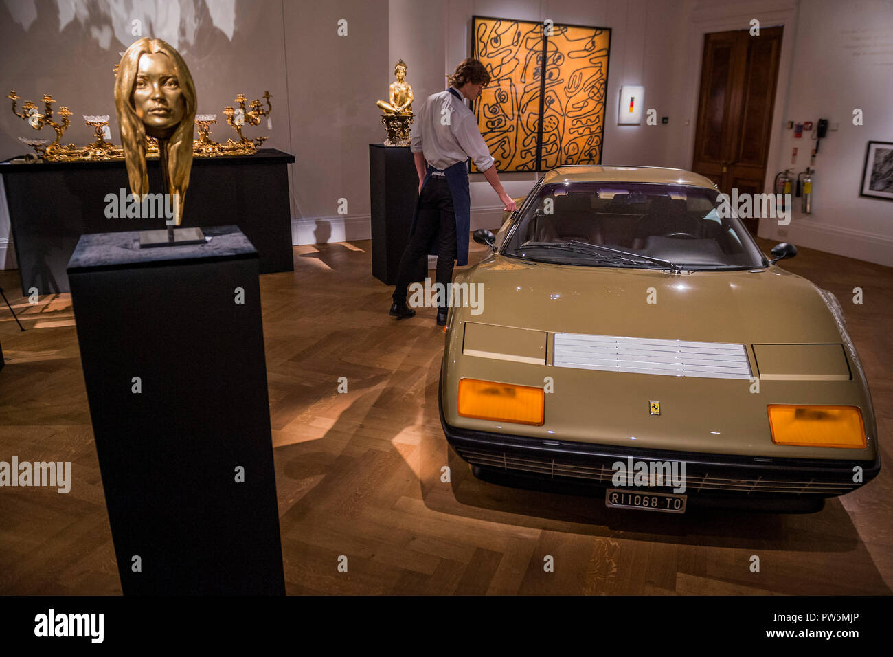 London, UK. 12th Oct 2018. A bust of Kate Moss in solid 18-carat gold by Marc Quinn, est £300-400,000 and a 1977 Gold Ferrari 512 BB, est £350-450,000 - The Midas Touch, a preview of a forthcoming sale dedicated entirely to Gold, at Sotheby’s New Bond Street, London.. Credit: Guy Bell/Alamy Live News Stock Photo