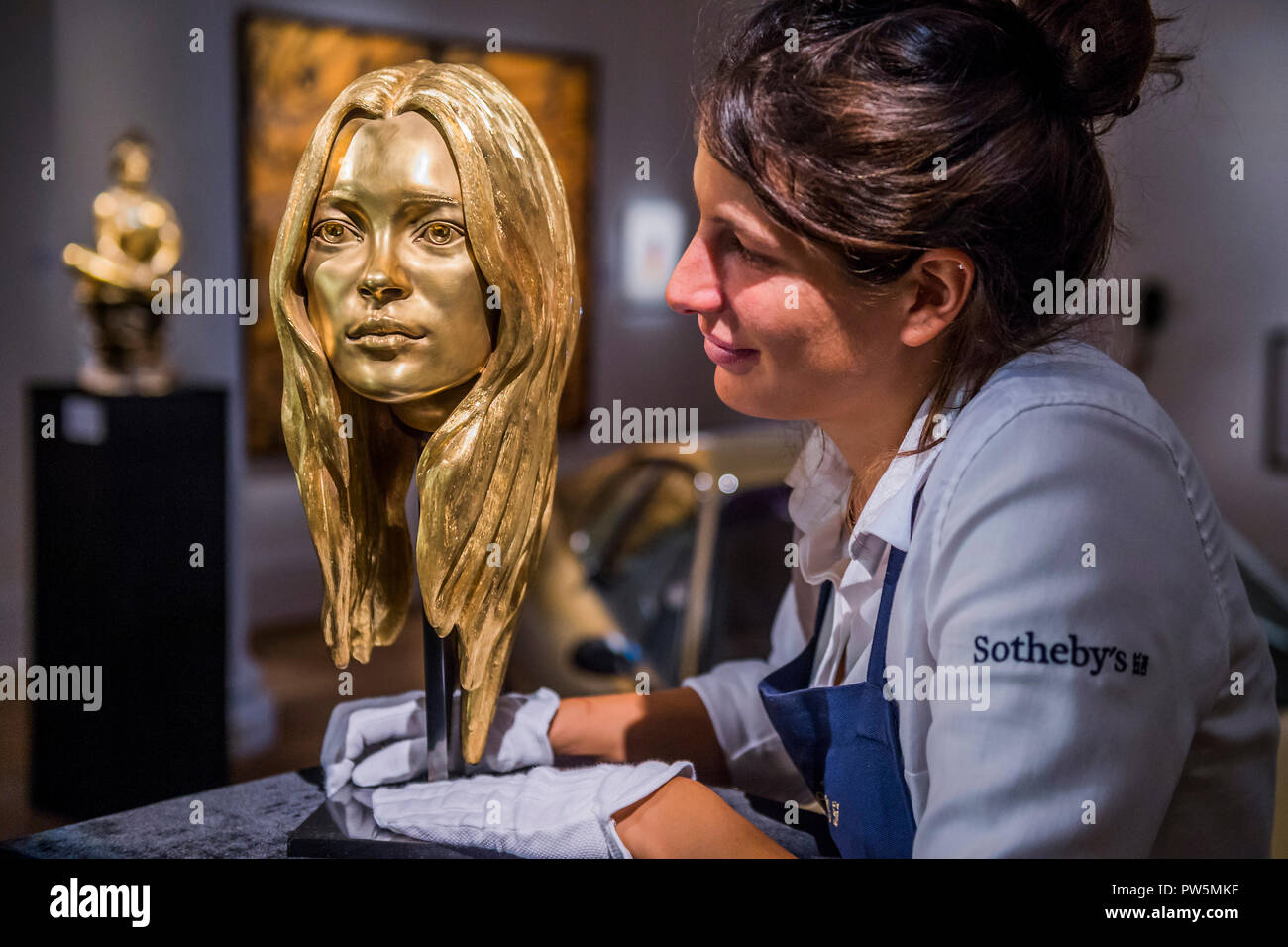 London, UK. 12th Oct 2018. A bust of Kate Moss in solid 18-carat gold by Marc Quinn, est £300-400,000 - The Midas Touch, a preview of a forthcoming sale dedicated entirely to Gold, at Sotheby’s New Bond Street, London.. Credit: Guy Bell/Alamy Live News Stock Photo