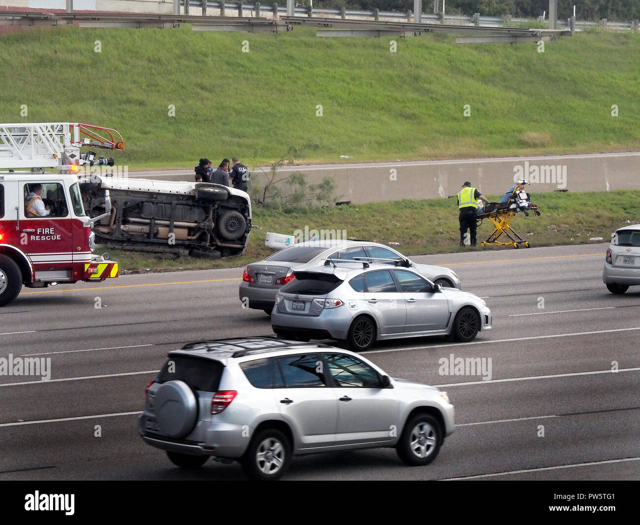 Car rolls over on interstate highway during rush hour. Mother and ...