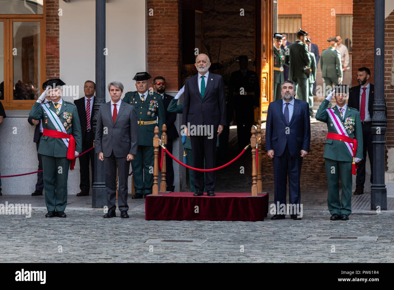 Madrid, Spain. 13th October, 2018. President of the Community of Madrid, ANGEL GARRIDO (left), General Director of the Guardia Civil, FELIX AZON and Delegate of the Government in Madrid, JOSE MANUEL RODRIGUEZ URIBES(right) attends the acts of celebration of the patron saint of the 'Guardia Civil', the Virgen del Pilar. During the ceremony, awards were given to personnel of the corps and a military parade and a parade took place in which personnel of different specialties of the 'Guardia Civil' participate on Oct 13, 2018 in Madrid, Spain Stock Photo