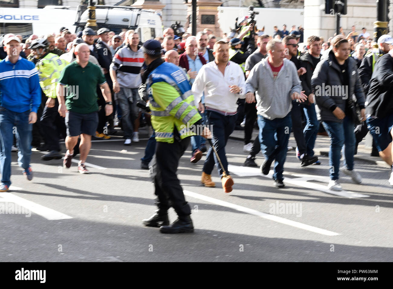 Democratic Football Lads Alliance DFLA marching towards Parliament, London, in protest demonstration. Marchers broke through a police cordon and scuffles took place. Lone officer outnumbered Stock Photo
